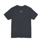 A plain black short-sleeve crewneck t-shirt shown from the back, with a 'Humble + Hopeful' laid flat against a solid white background.