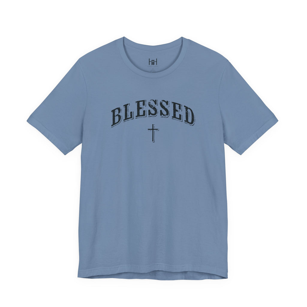 A light blue crewneck t-shirt with 'BLESSED' and a cross printed in black on the chest, displayed against a solid white background.