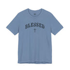 A light blue crewneck t-shirt with 'BLESSED' and a cross printed in black on the chest, displayed against a solid white background.