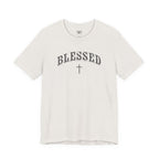 A white short-sleeve crewneck t-shirt featuring the word 'BLESSED' in an arched, distressed black font with a matching cross underneath, displayed on a clean white background.
