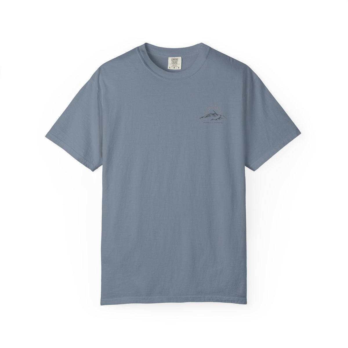 Blue jean color t-shirt with small mountain design and 'humble and hopeful' text on a white background.