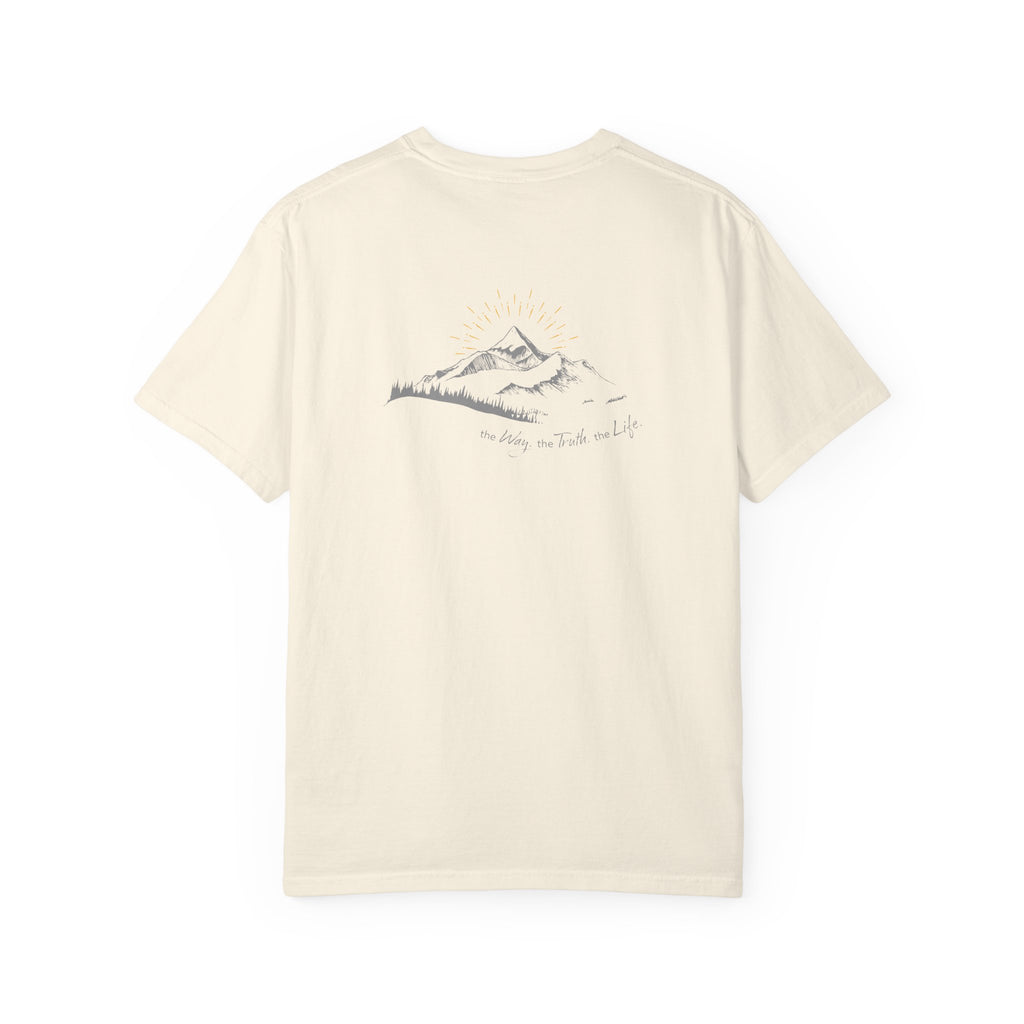 An ivory t-shirt with a mountain with a rising sun and the Way, the Truth, the Life text printed underneath the graphic on a white background.