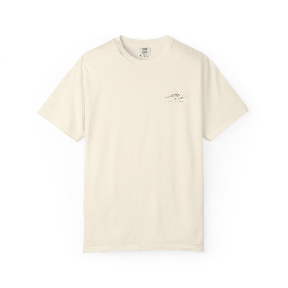 Ivory t-shirt with small mountain design and 'humble and hopeful' text on a white background.