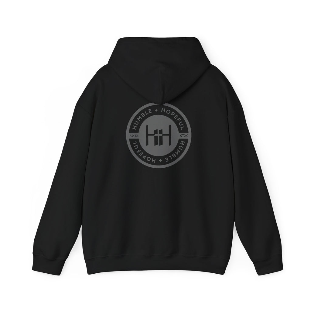 Black hoodie with 'Humble+Hopeful' logo on the back against a white background
