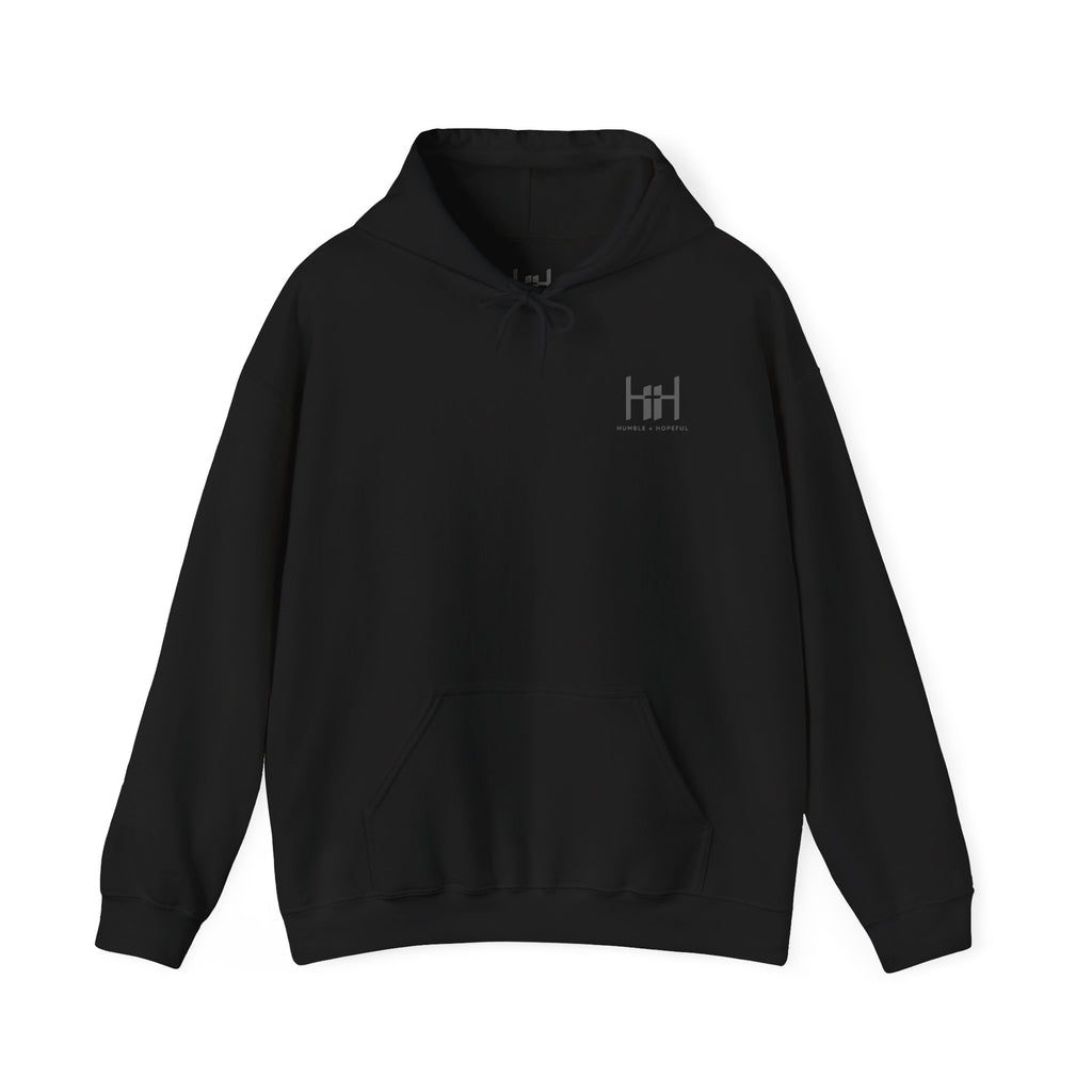 Black hoodie with 'Humble+Hopeful' logo on the back against a white background