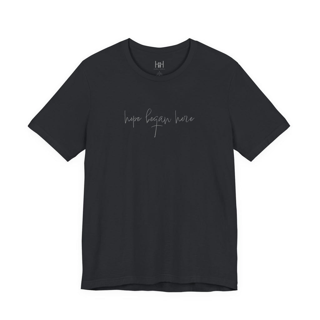 black t-shirt with 'hope began here' text on a white background