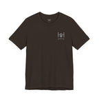 Brown t-shirt with the Humble + Hopeful logo on it on the white background