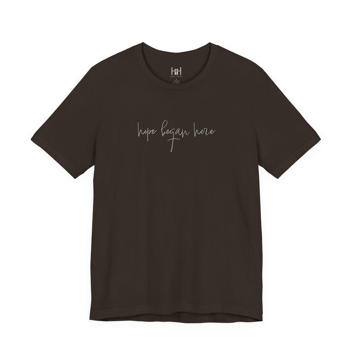 a brown t-shirt with 'hope began here' written on it on a white background