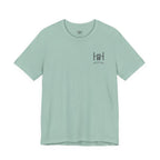 the front of a dusty blue t-shirt with the Humble + Hopeful logo on it