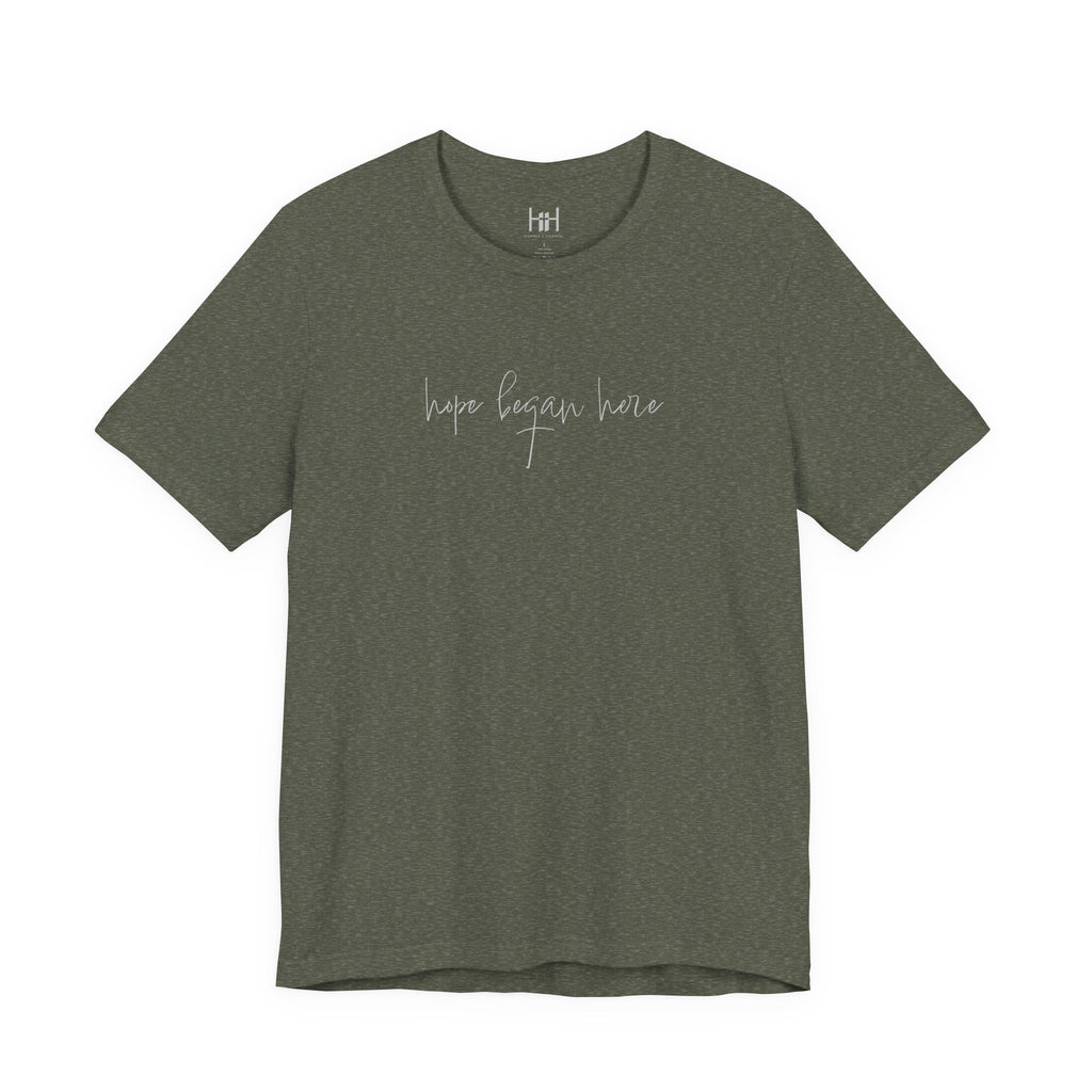 military green t-shirt with 'hope began here' text on a white background