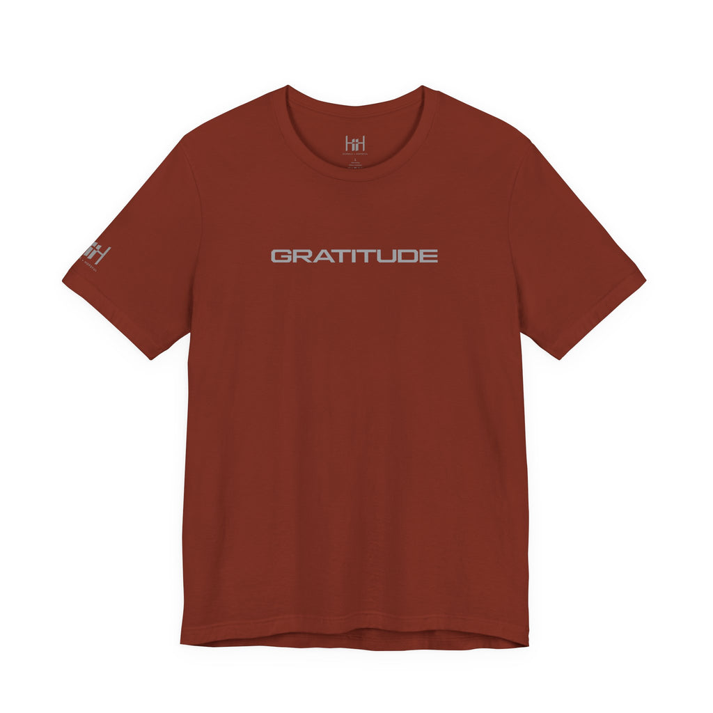 Rust colored t-shirt with 'GRATITUDE' written on the front on a white background