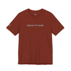 Rust colored t-shirt with 'GRATITUDE' written on the front on a white background