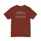 rust t-shirt with 'Humbled+Forgiven' text on the back against a white background