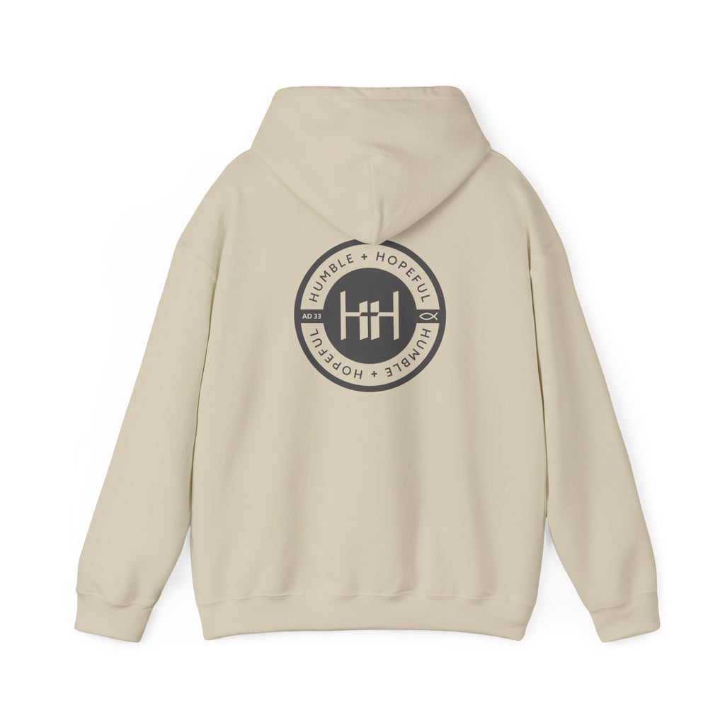 Sand hoodie with 'Humble+Hopeful' logo on the back against a white background