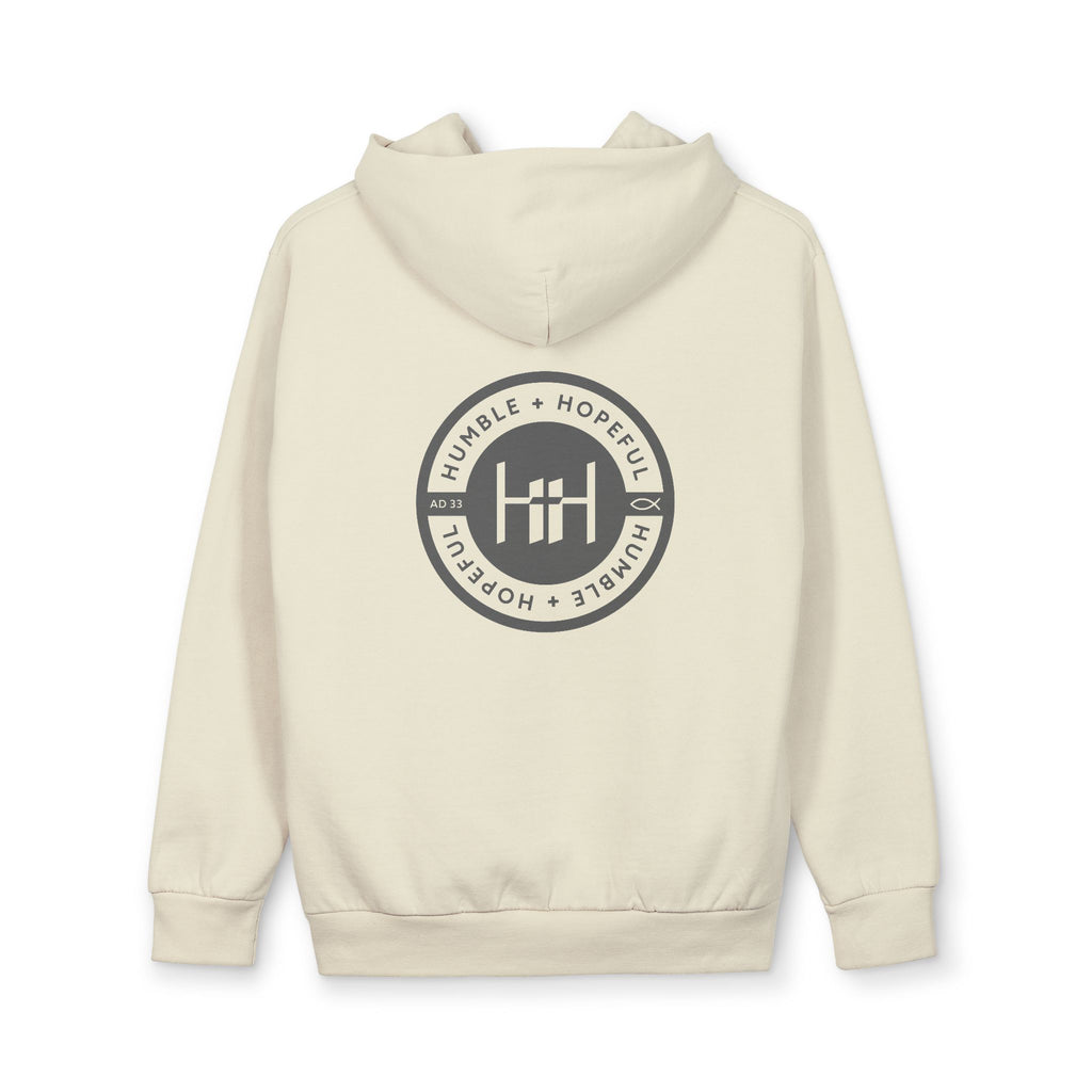 Sandshell colored hoodie with 'Humble+Hopeful' logo on the back against a white background