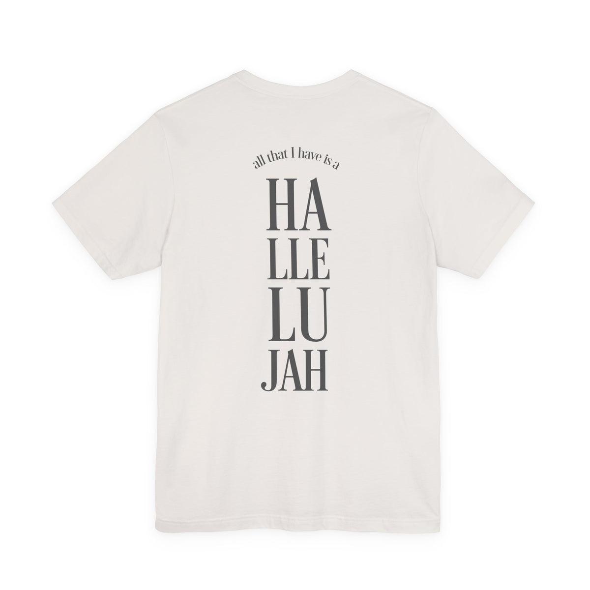 An off-white short-sleeve t-shirt shown from the back, featuring a vertical graphic print that reads 'all that I have is a Hallelujah' in dark gray text.